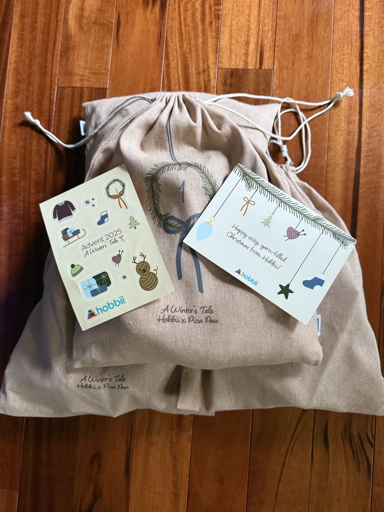 Hobbii amigurumi advent calendar for 2025 by Pica Pau: 4 project kits in drawstring bags and a postcard and stickers for the "winter's Tale" theme