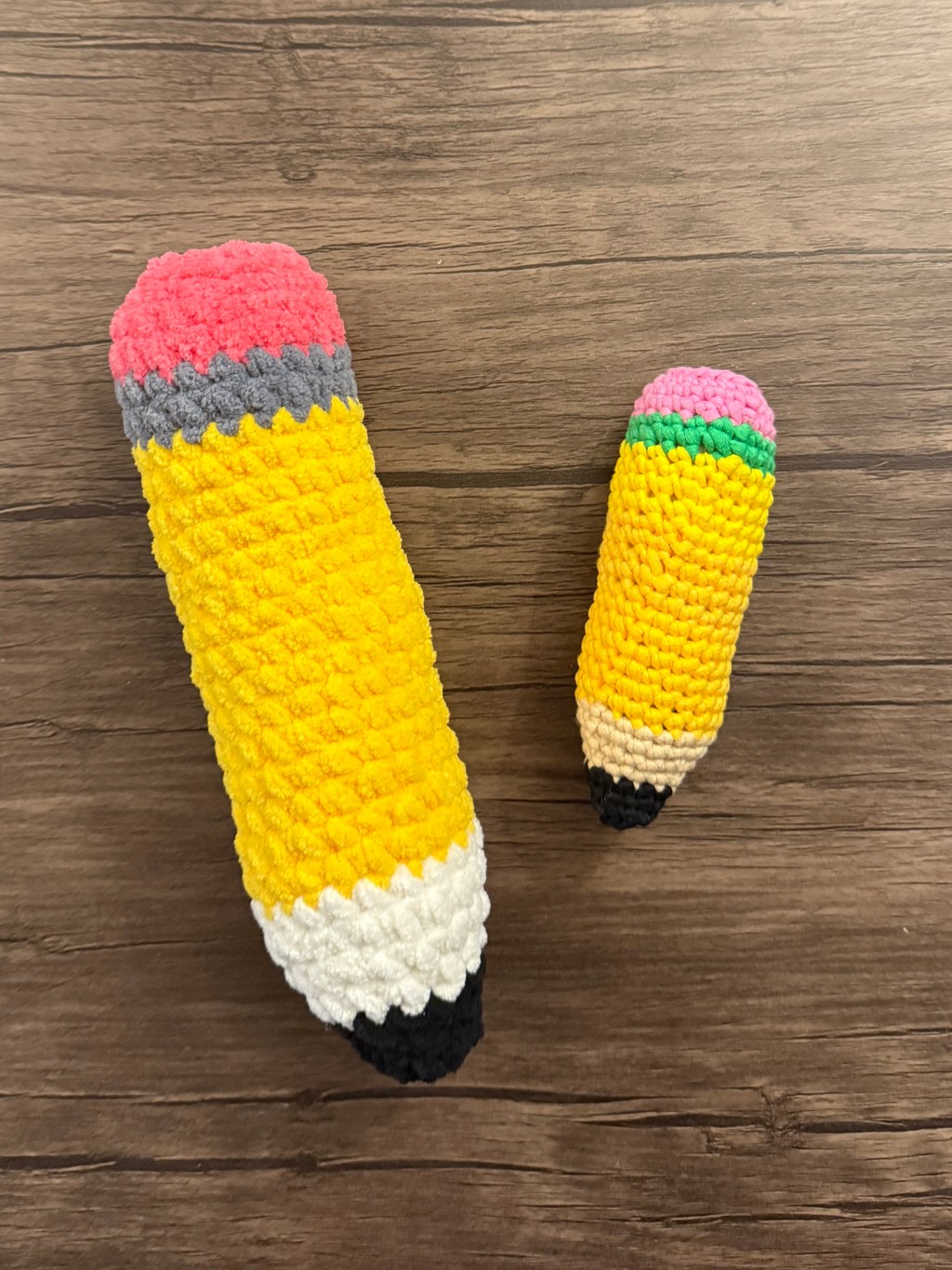 2 crocheted amigurumi pencil plushies -- 1 big made with chenille yarn and 1 small made with Woobles yarn