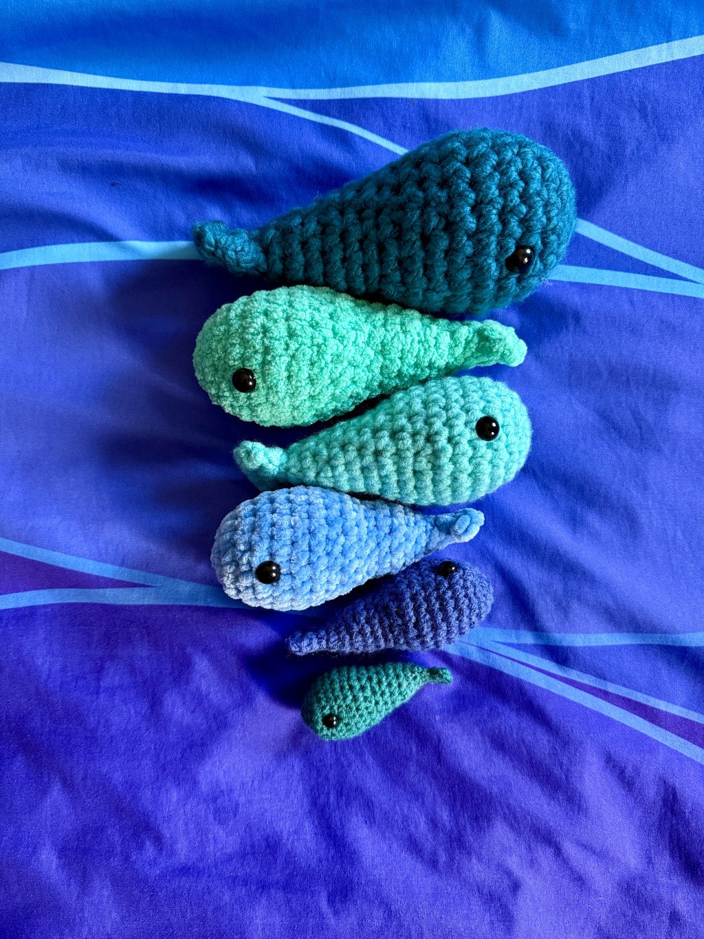 6 crocheted amigurumi finished object whales made from various types and weights of Premier Basix yarns