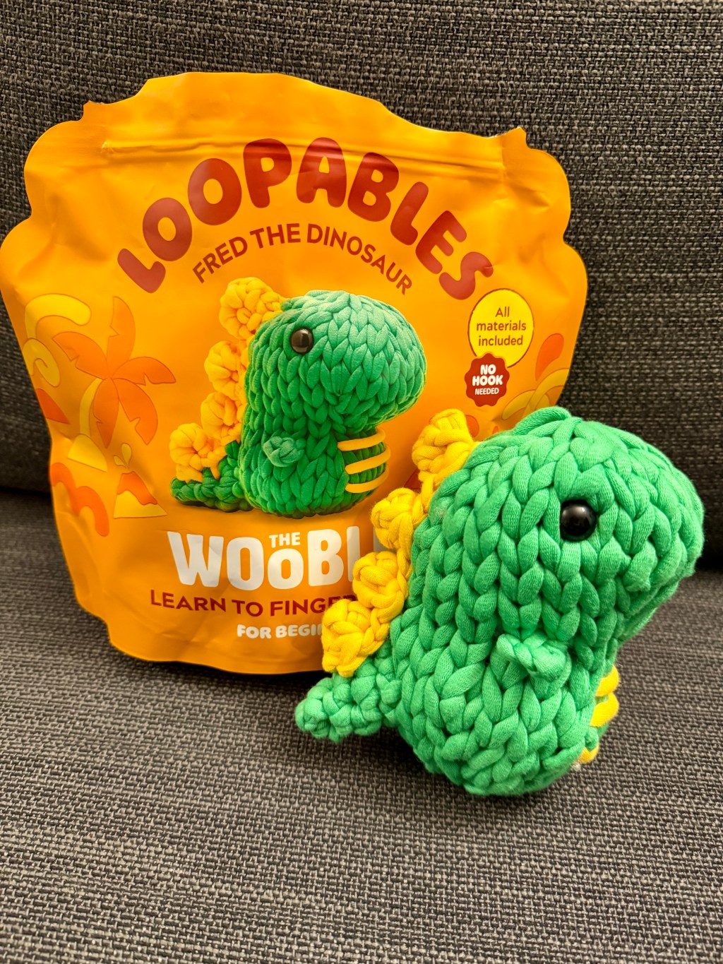 Fred the Dino finger-looped amigurumi plushie toy handmade finished object made from Woobles Loopables craft kit