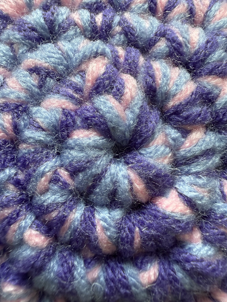 Marbled Star crochet plush pillow close-up with 3 strands of yarn marled together: Dreamy Midnight Night color palette (pink, periwinkle, and purple)
