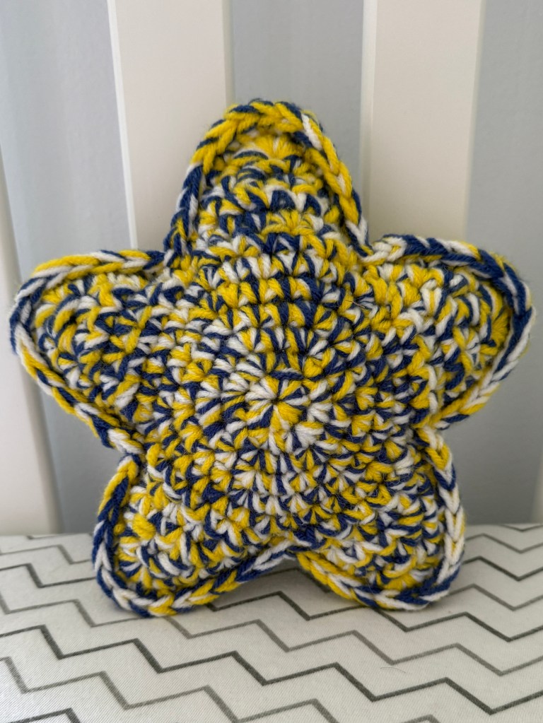 Marbled Star handmade crocheted amigurumi pillow plushy, made by marling 3 strands of yarn together -- Starry Night color palette (yellow, blue, and white)