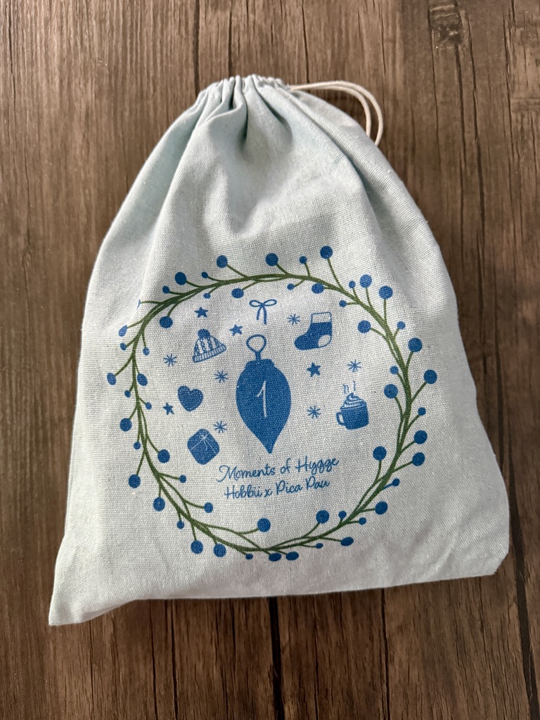 Project kit in a drawstring bag for Hobbii amigurumi advent calendar for 2026 by Pica Pau Moments of Hygge theme